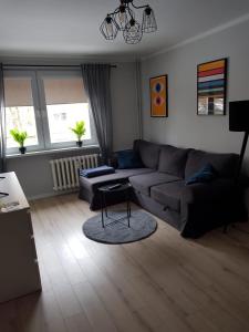 a living room with a couch and a table at Apartament Monika in Kłodzko