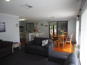 a living room with a couch and a table at Port Relaxation in Portarlington