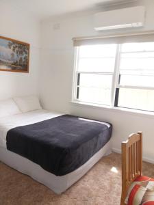 a bedroom with a bed and a window at Peaceful Home in Bendigo