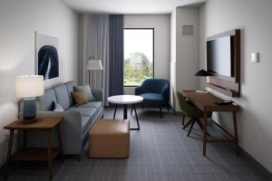 a living room with a couch and a table at Staybridge Suites - Colorado Springs NE Powers, an IHG Hotel in Colorado Springs