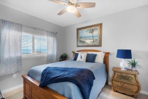 a bedroom with a bed and a ceiling fan at Emerald Isle unit 1206 in Pensacola Beach +38 photos