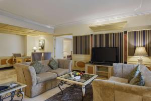 a living room with two couches and a flat screen tv at Park Plaza, Ludhiana in Ludhiana