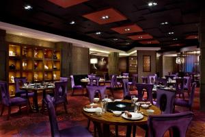 a dining room with tables and purple chairs at Park Plaza Beijing Science Park in Beijing
