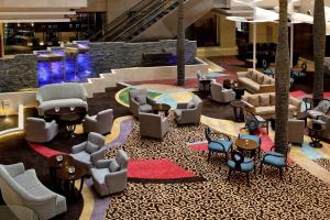 a lobby with couches and chairs in a building at Park Plaza Beijing Science Park in Beijing