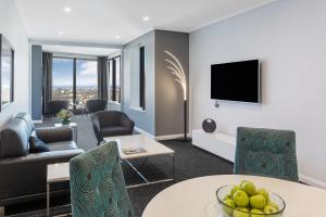 a living room with a couch and a table at Meriton Suites World Tower, Sydney in Sydney