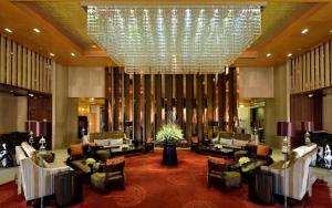 a large lobby with couches and a chandelier at Radisson Blu Jaipur in Jaipur