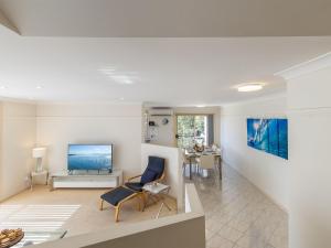a living room with a tv and a couch at Sea Breeze, 1,23 Stubby St Nelson Bay - Pet Friendly duplex with boat parking, air con and wi-fi in Nelson Bay