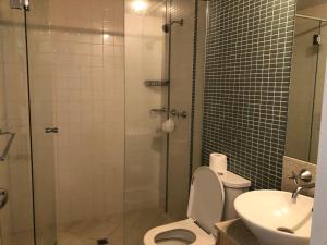 a bathroom with a shower and a toilet and a sink at Sebel 302 - Deluxe Apartment in Maroochydore