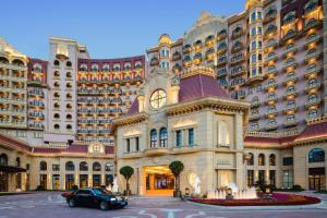 a large building with a car parked in front of it at Radisson Blu Forest Manor Shanghai Hongqiao in Shanghai