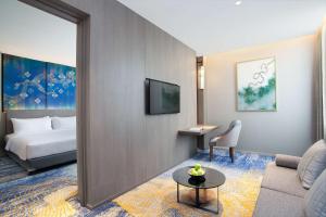Ένα ή περισσότερα κρεβάτια σε δωμάτιο στο Radisson Lampung Kedaton