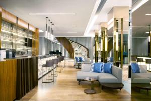 a lobby with couches and a bar at Radisson Lampung Kedaton in Bandar Lampung