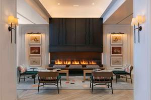 a living room with a fireplace and a table and chairs at The Royal Sonesta Chicago Downtown in Chicago
