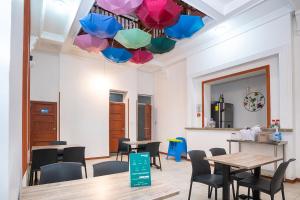 a room with tables and chairs and colorful umbrellas at Ayenda Acacia in Ibagué
