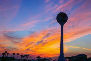 a clock tower with a sunset in the background at Sans Souci unit 601 in Pensacola Beach