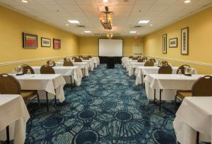 a conference room with tables and a whiteboard at Best Western Plus Strongsville Cleveland in Strongsville