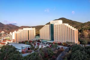 an aerial view of a hotel with mountains in the background at Sono Moon Danyang in Danyang