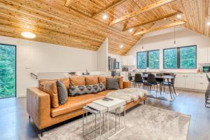 a living room with a brown couch and a kitchen at Wyeast Trail in Government Camp