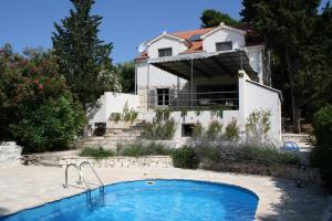 a house with a swimming pool in front of a house at Villa Tamara in Bol