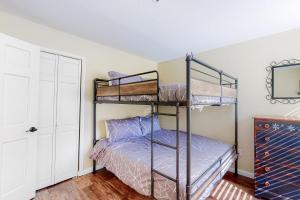 a bedroom with two bunk beds and a mirror at Wildernest Rest in Silverthorne