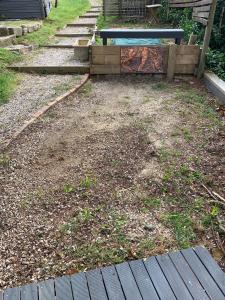 a backyard with a wooden fence and a mattress at Flying Fox Backpackers in Katoomba