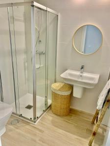 a bathroom with a glass shower and a sink at Marina Real 82 by homeprive in Denia +44 photos