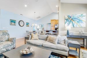 a living room with a couch and a table at The Tides --- 19967 Sandy Bottom in Rehoboth Beach