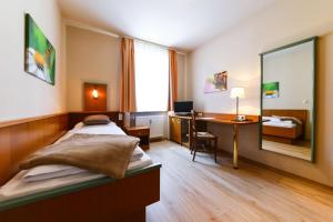 Postel nebo postele na pokoji v ubytování Boardinghouse Pfarrkirchen