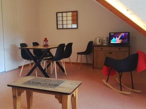 a room with a table and chairs and a television at Appartement Saint-François-Longchamp, 2 pièces, 4 personnes - FR-1-635-10 in Saint-François-Longchamp