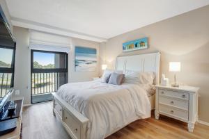 a bedroom with a large white bed and a window at Sea Colony --- 208 Brandywine House in Bethany Beach +40 photos