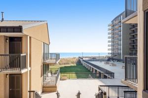 a view of the beach from the balcony of a building at Sea Colony --- 208 Brandywine House in Bethany Beach
