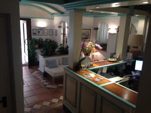 a living room with a reception desk and a couch at Hotel Terranova in Olbia