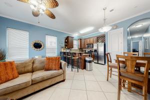 a living room with a couch and a kitchen at Saturn Serenity & Condo in South Padre Island