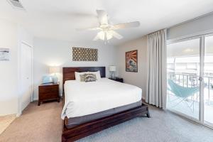 a bedroom with a bed and a ceiling fan at Bayou Village 610 in Destin