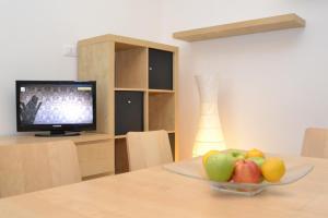 a bowl of fruit on a table with a television at Villa with beach place in Bibione