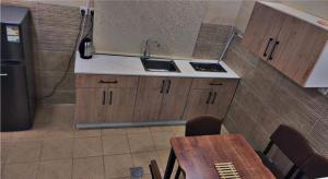 a kitchen with a sink and a table with a phone at الشاطئ الأبيض للشقق المخدومة in Rayyis