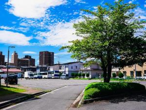 a street with a tree in a parking lot at Hachinohe Plaza Hotel in Hachinohe