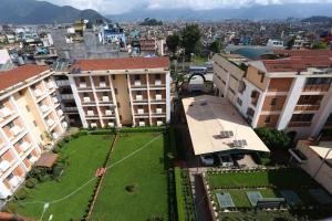 an aerial view of a city with buildings and a lawn at Alpine Hotel & Apartment in Kathmandu