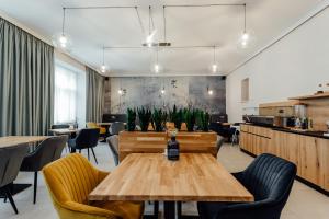 a dining room with a wooden table and chairs at Boutique Hotel Siglisberg in Banská Štiavnica