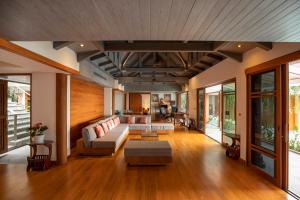 a living room with a couch and a table at Rachawadee Surin Beach-SHA Extra Plus in Surin Beach +65 photos