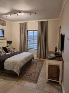 a bedroom with a bed and a television in it at Bondi Beach Villa in Margate