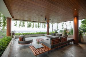 a living room with a couch and a table at Rachawadee Surin Beach-SHA Extra Plus in Surin Beach