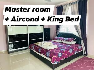 a bedroom with a master room attend king bed at No 11 Nazirin Homestay Tmn Desa Manjung Lumut in Lumut