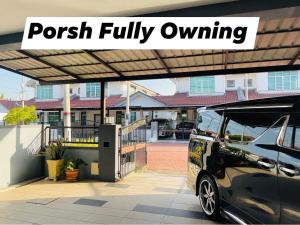 a van parked under awning with the words pouch fully owning at No 11 Nazirin Homestay Tmn Desa Manjung Lumut in Lumut