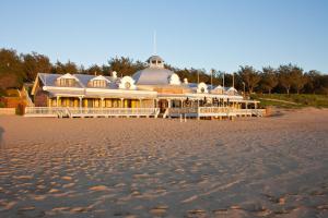 a large building on the beach next to the sand at Santos Beach Pavilion - Flat B in Mossel Bay