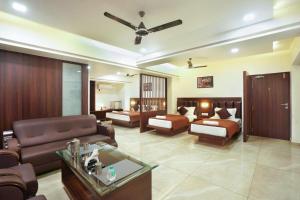 a living room with a couch and a bed at Sayaji Lodging in Gārgoti +27 photos