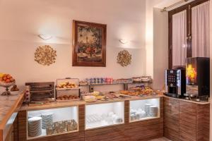 a kitchen with a buffet table with cakes and pies on it at Anacapri in Granada