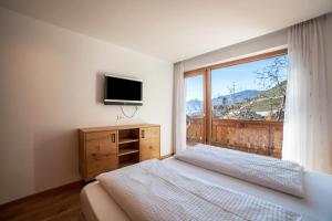 En eller flere senge i et værelse på Oberegghof Ferienwohnung Ifinger