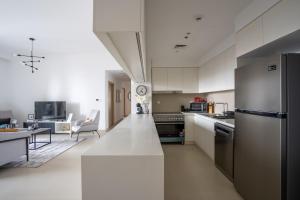a kitchen with white cabinets and a white counter top at HiGuests - Artistic Apt with Balcony Overlooking Dubai Canal in Dubai