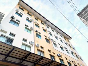 a tall white building with many windows at airobedz MANILA - A Value Hotel in Manila