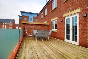 a deck with chairs and a table on a building at DELFT - Spacious Home, High Speed Wi-Fi, Free Parking, Terrace in Swindon